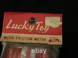 1960s T. T JAPANESE TIN LITHO FRICTION TOY CHAMPION #12 SPORTS CAR, IN THE PACKAG