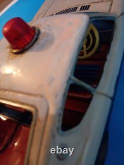 A 1970s Nissan Fairlady Z tin toy, made in Japan, 30cm long, police car