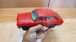 Datsun (Nissan) Sunny 1000. Red car tin toys Japan. Vintage retro car litho tin