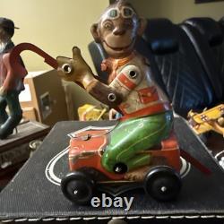 Tin Windup Monkey Driving A Car